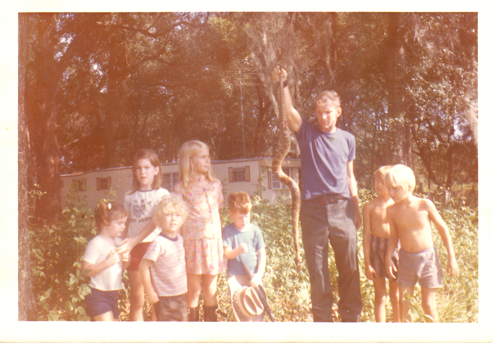 I'm the one on the far left trying to hold back the small children from the still writhing snake. My brother, Scott is the small redhead with the toy gun.