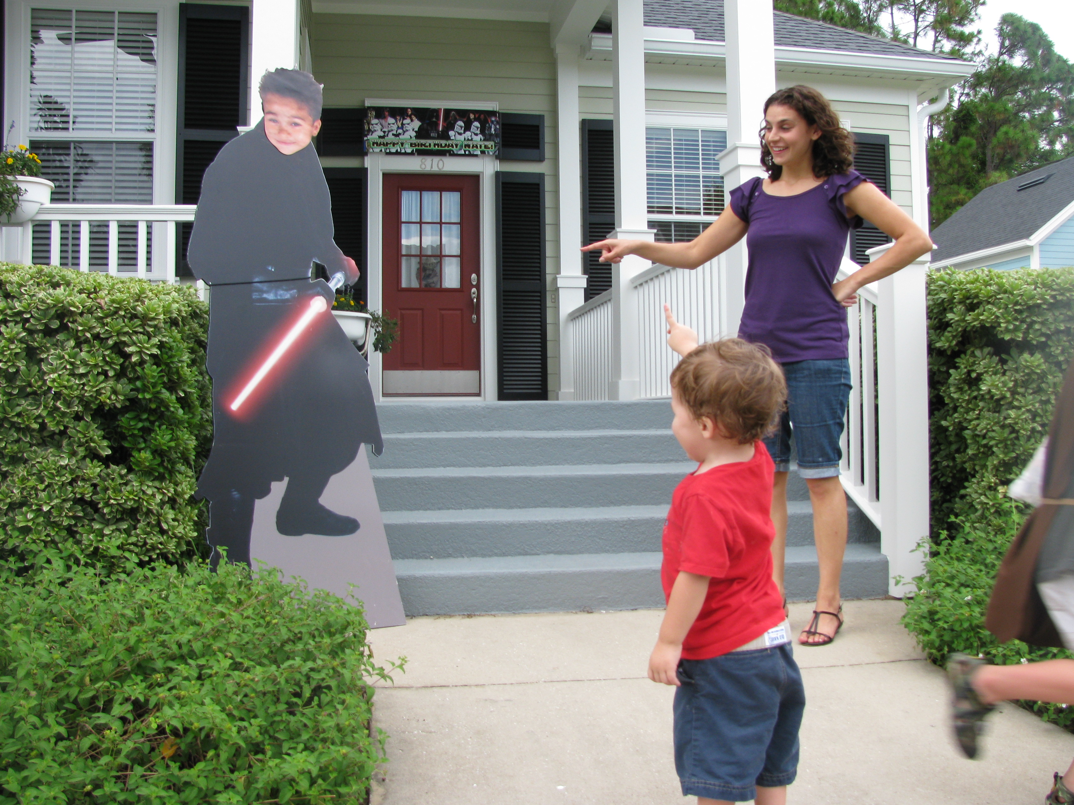 Mark brought home a life-sized Darth Maul. "We're trying not to emotionally scar the kids for life, Mark!" So he taped a photo of Nate on it! Danielle and Zeke check out his handy work.